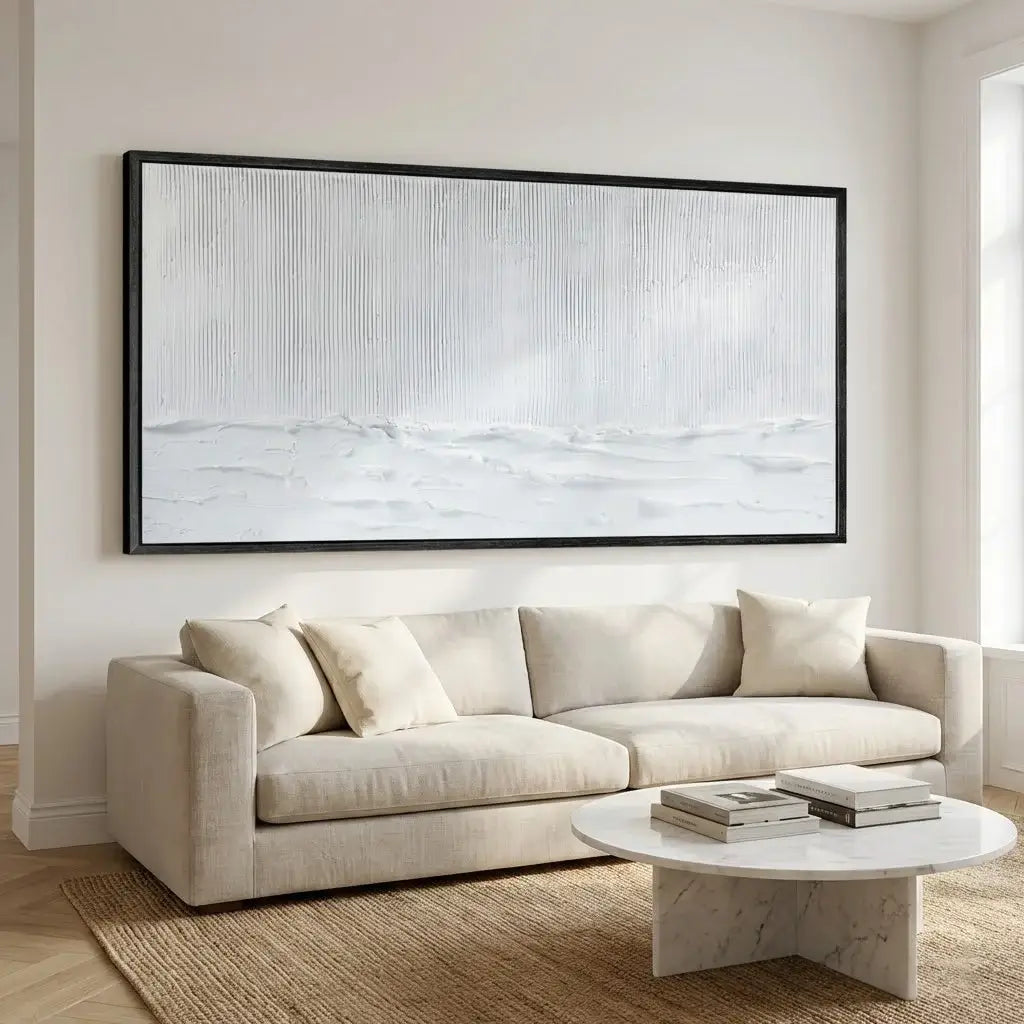 Beige sofa in a living room with a large abstract painting above it.