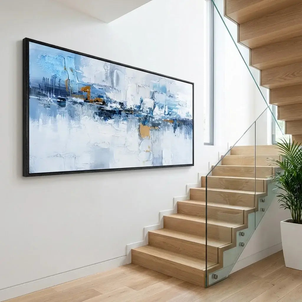 Modern interior with a large abstract painting on the wall above a staircase.