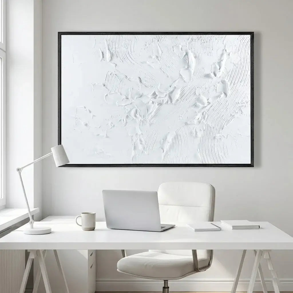 Modern office setup with a desk, chair, lamp, and abstract artwork on a white wall.