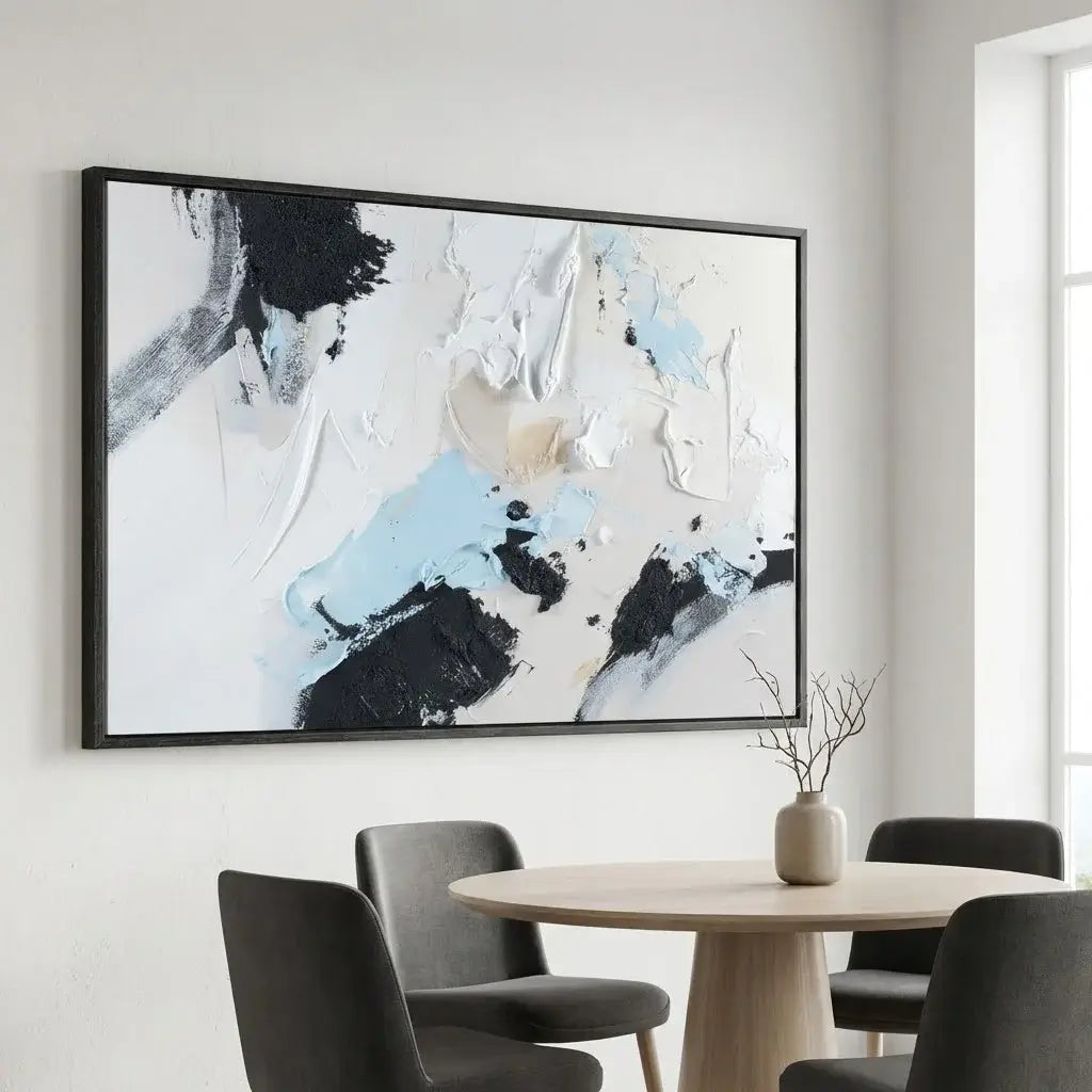 Abstract painting in a modern interior setting with a round table and chairs.