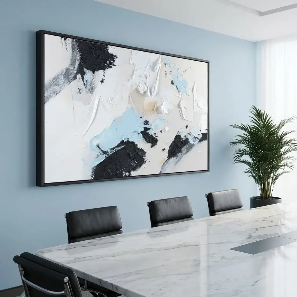 Modern conference room with abstract art on the wall, marble table, and black chairs.