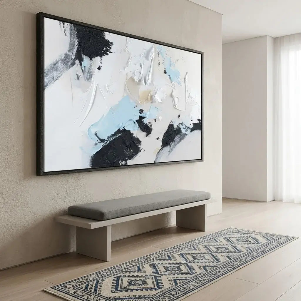 Abstract painting on a wall above a bench with a patterned rug on the floor.