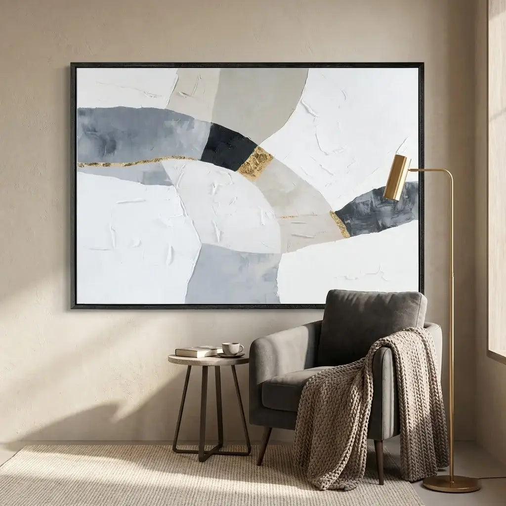 Modern interior with abstract art on the wall, a chair, and side table.