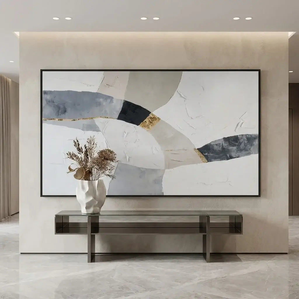 Abstract painting on a wall with a vase and flowers in the foreground