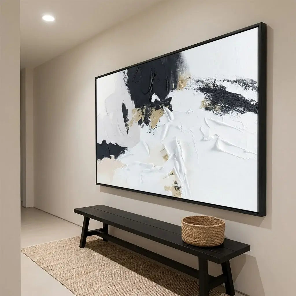 Abstract painting on a wall above a black bench with a woven basket in a room.