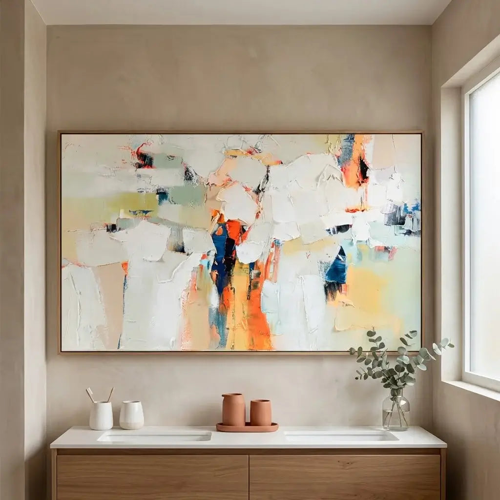 Abstract painting on a wall above a bathroom vanity with decor items.