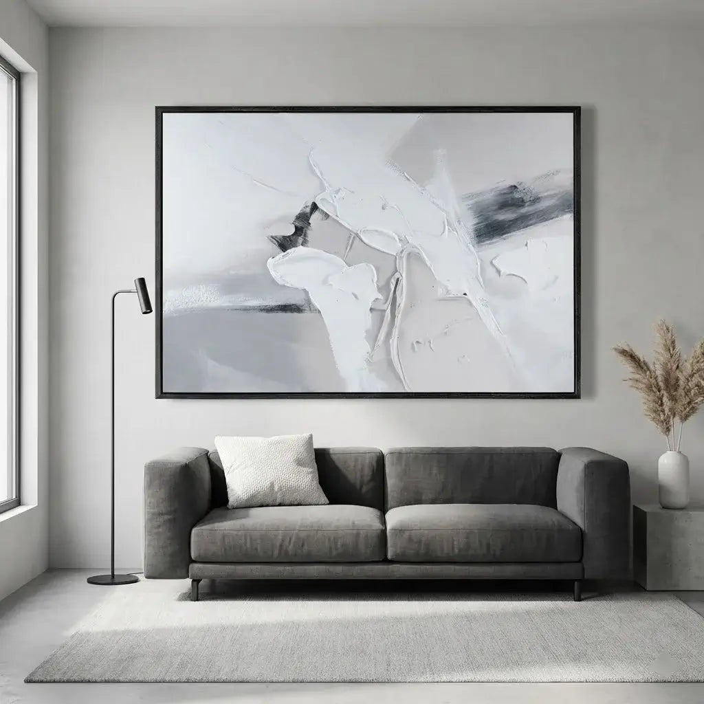 Living room with a gray sofa, abstract painting, and floor lamp.