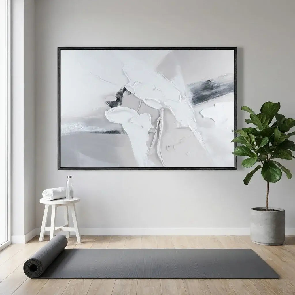 Yoga mat on wooden floor with abstract art and plant in room
