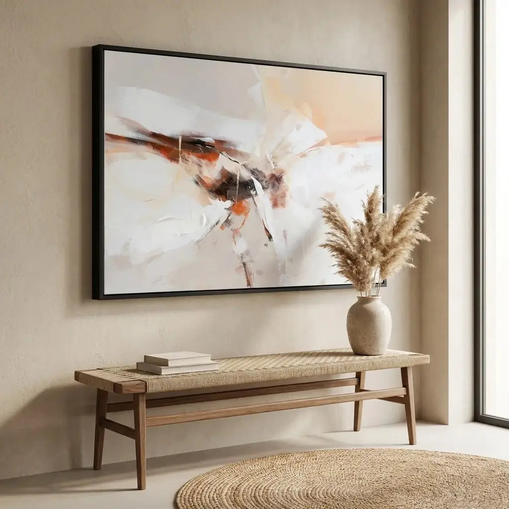 Abstract painting on a wall above a wooden bench with a vase and books.
