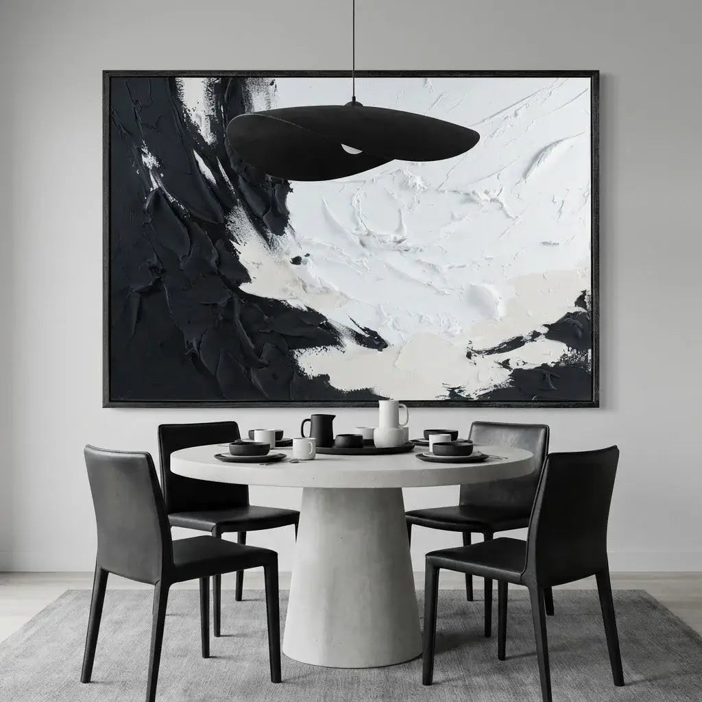 Dining room with a round table and chairs, abstract black and white painting on the wall.