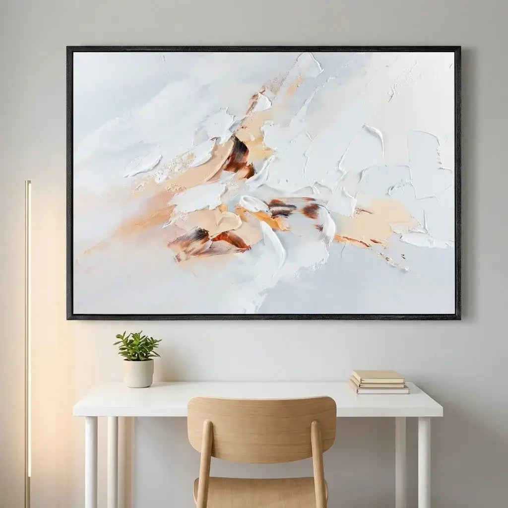 Abstract painting on a wall above a desk with a chair and books.