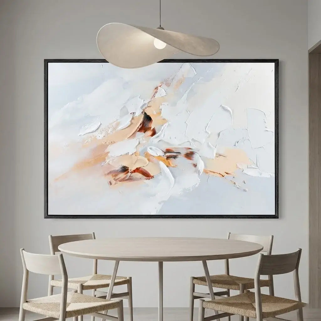Abstract painting in a modern dining room with a round table and chairs.