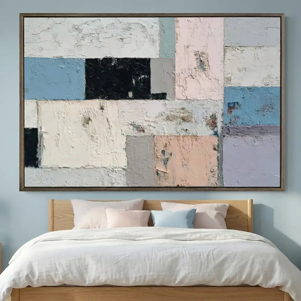 Abstract art painting above a bed with light blue walls