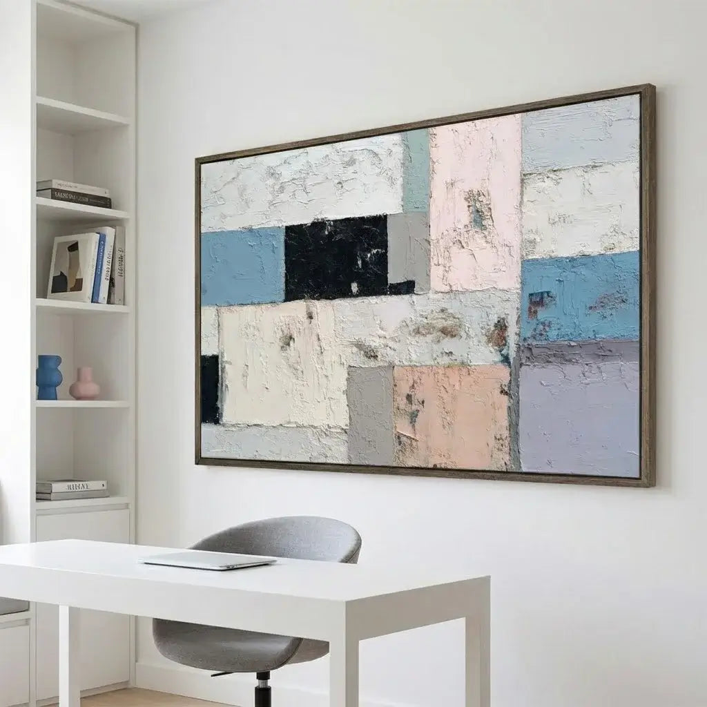 Abstract art piece on a wall above a desk in a home office setting
