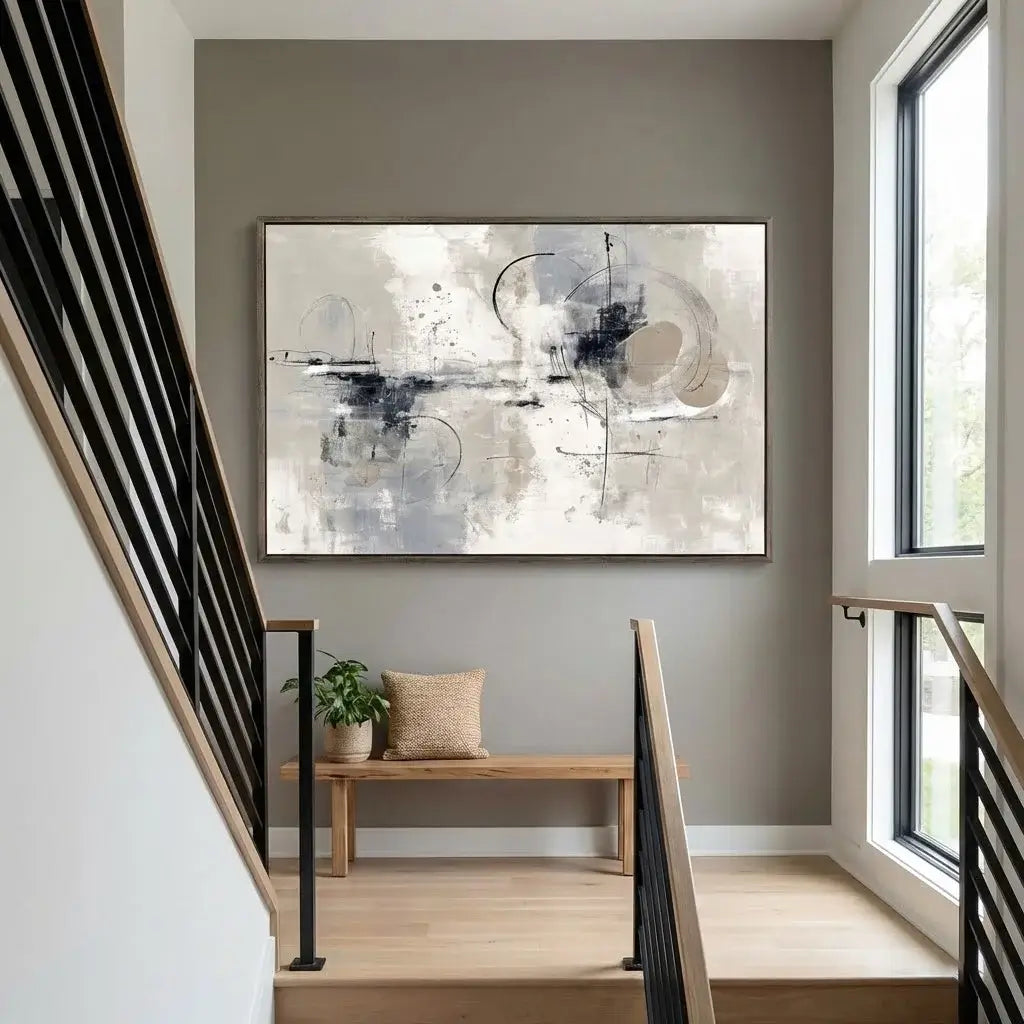 Modern interior with abstract art on a wall, wooden bench, and plant.
