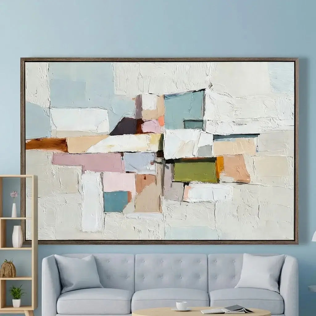 Abstract art piece on a wall above a sofa in a living room.