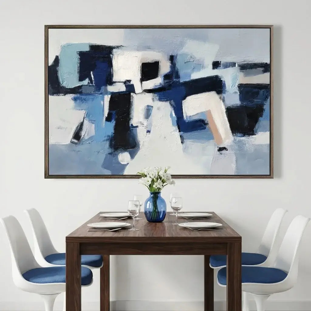 Dining room with a wooden table, white chairs, and abstract art on the wall.