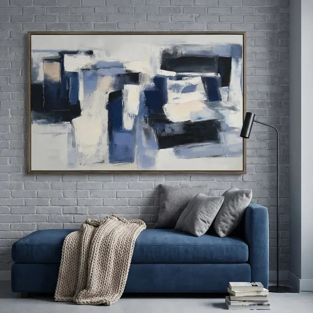 Abstract painting above a blue sofa with a textured wall background