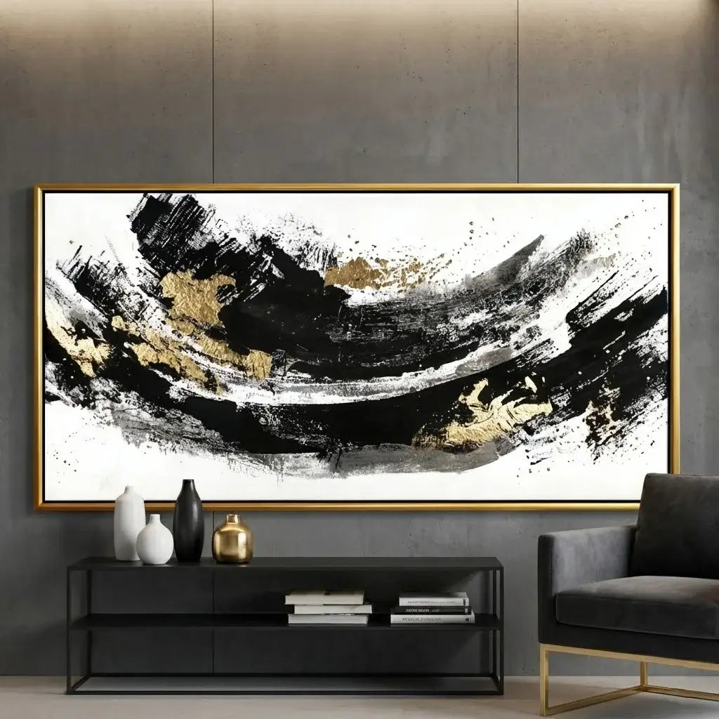 Abstract art piece with black and gold brush strokes in a modern living room setting.