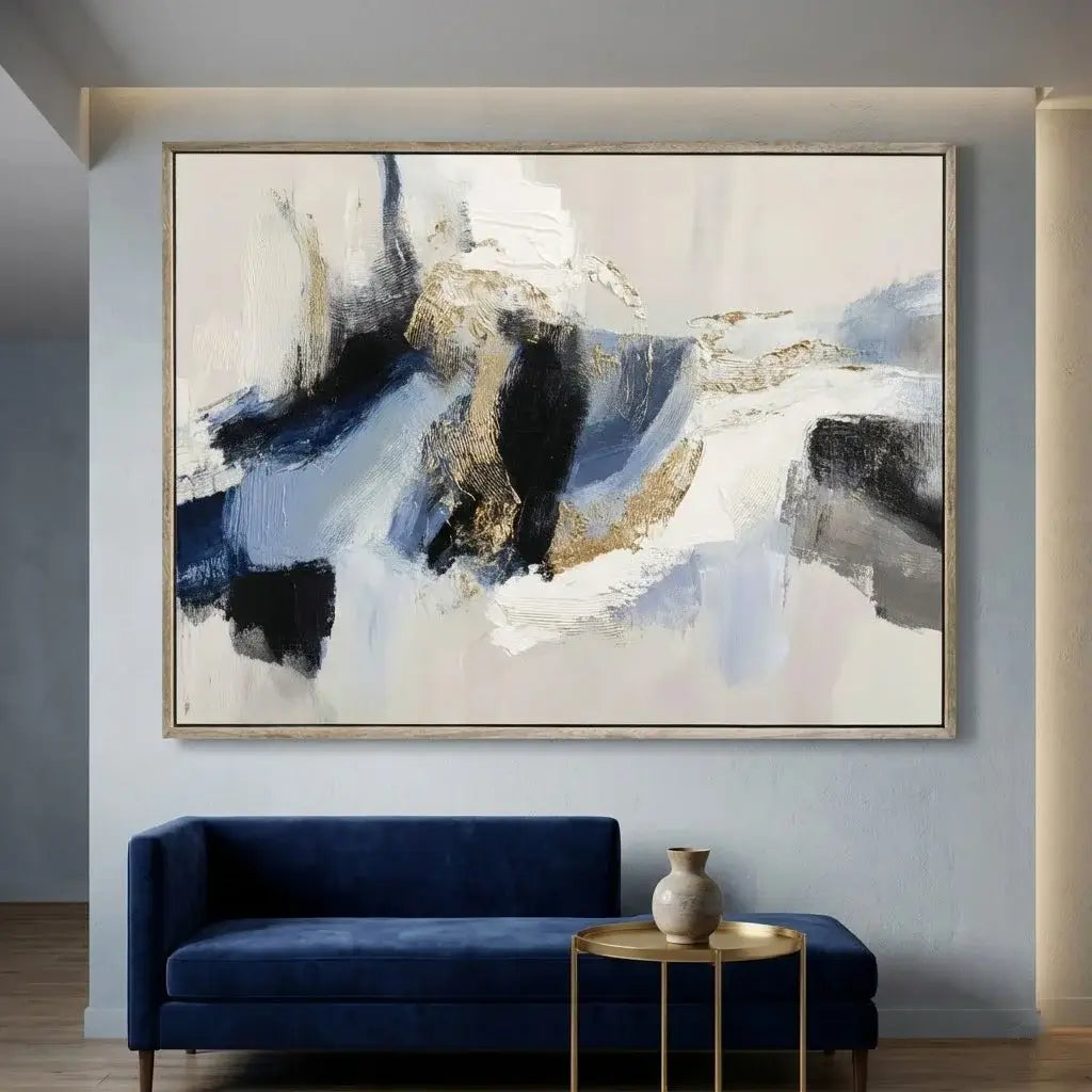 Abstract painting on a wall above a blue sofa in a living room.