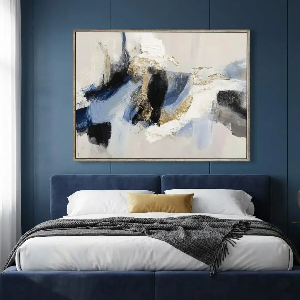 Abstract painting on a blue wall above a bed with white bedding and a dark headboard.