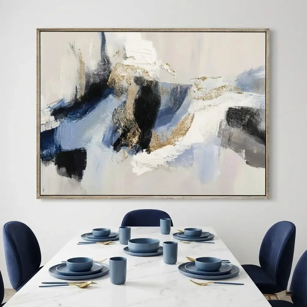 Dining room with abstract art on the wall and set table.