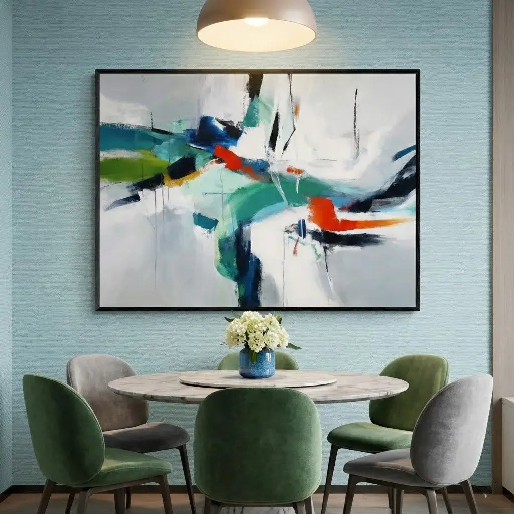 Dining room with a round table and chairs, abstract painting on the wall, and a vase with flowers.