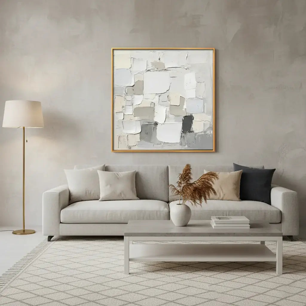 Modern living room with a gray sofa, abstract art, and decorative items.