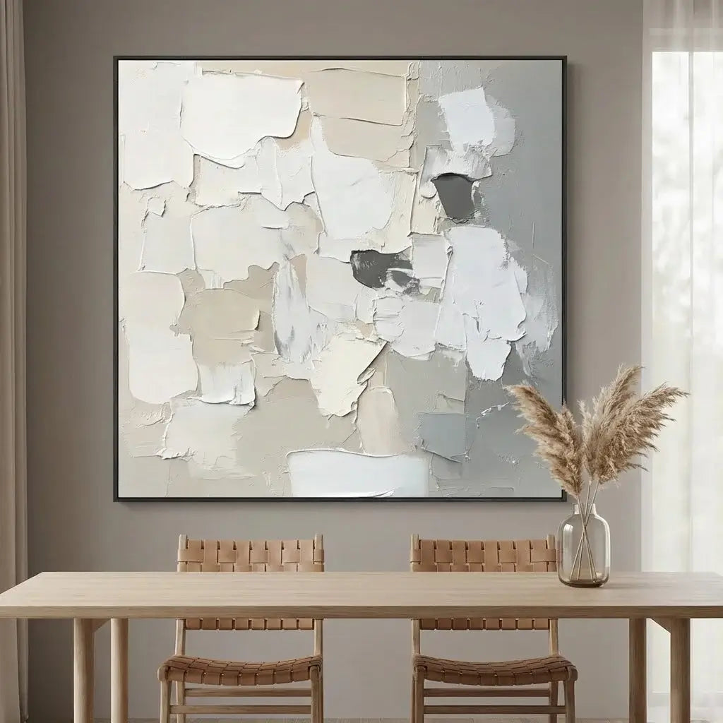 Abstract painting on a wall above a dining table with chairs.