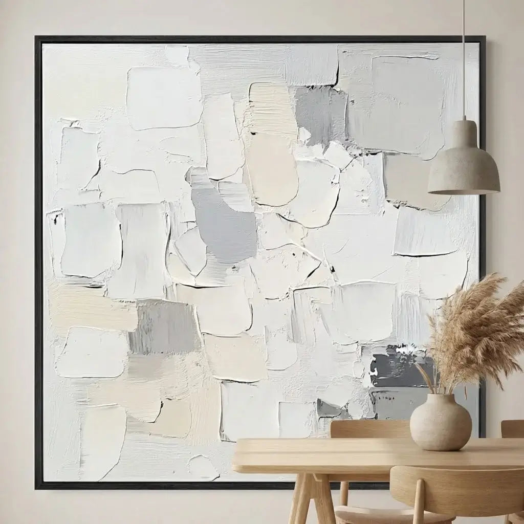 Abstract art piece in a modern interior setting with a table and lamp.