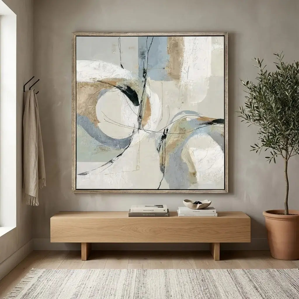 Modern living room with abstract art, wooden console table, and potted plant.