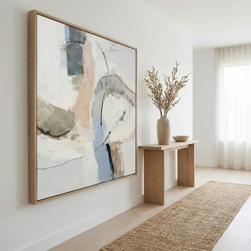 Abstract painting on a wall in a modern interior setting with a console table and decor items.