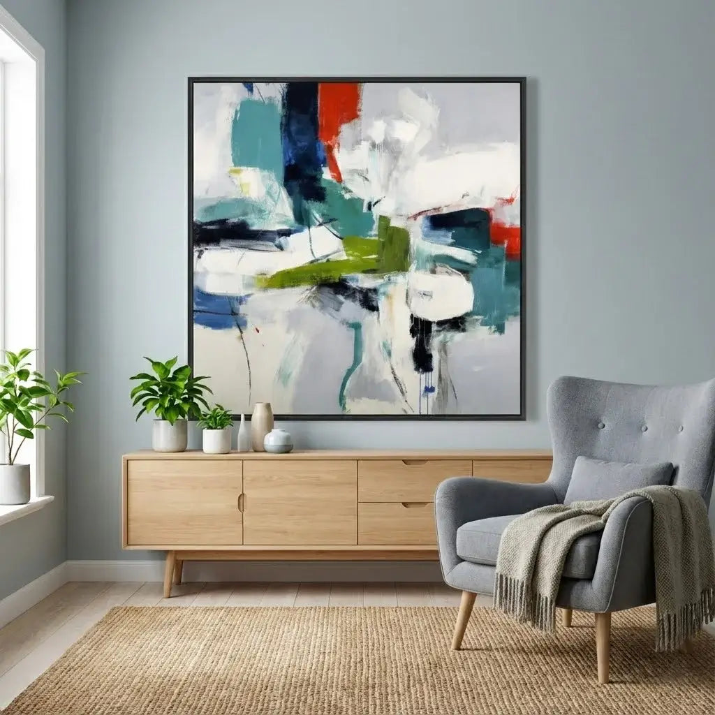 Living room with abstract art, wooden cabinet, and gray armchair.