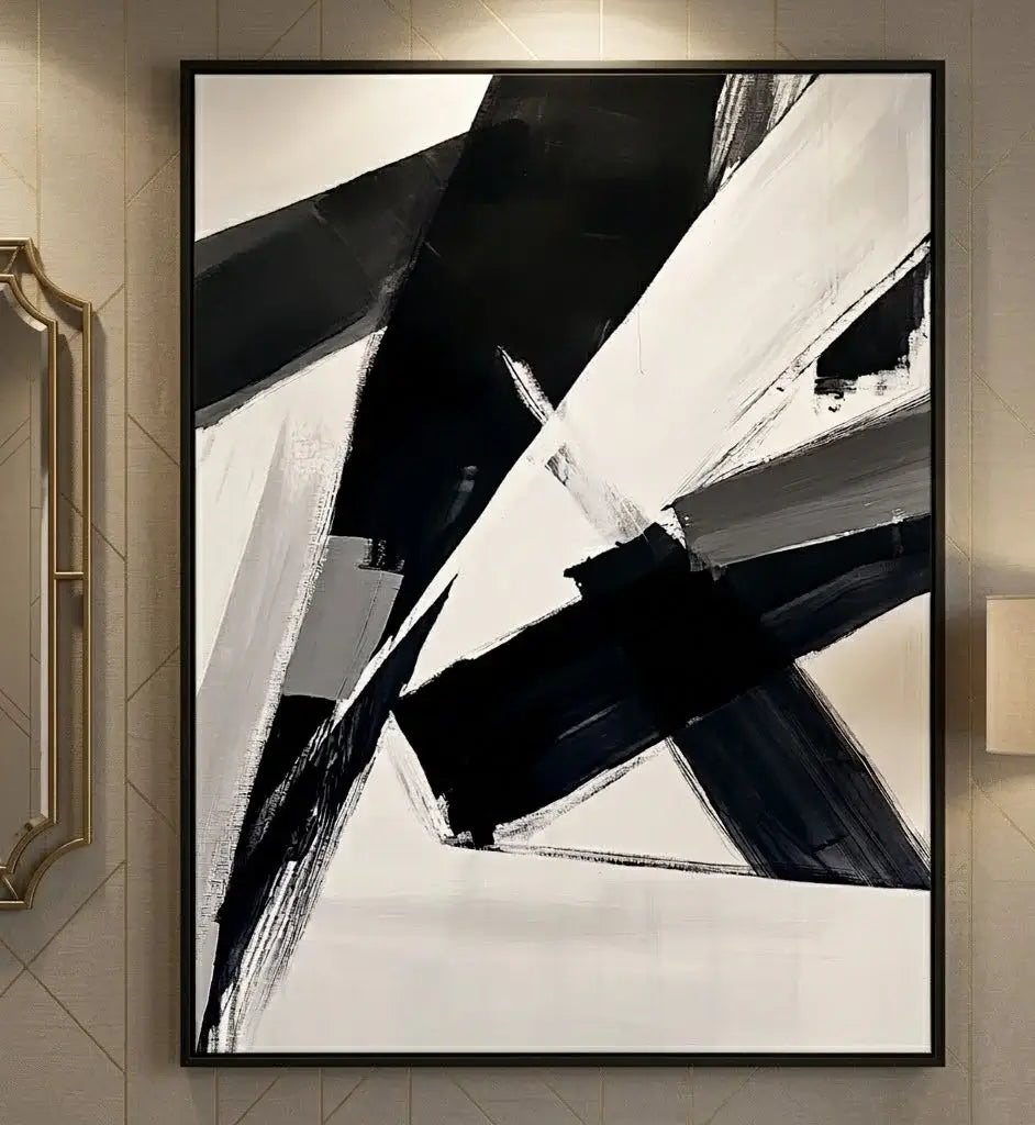 Modern living room with abstract black and white artwork above a fireplace.