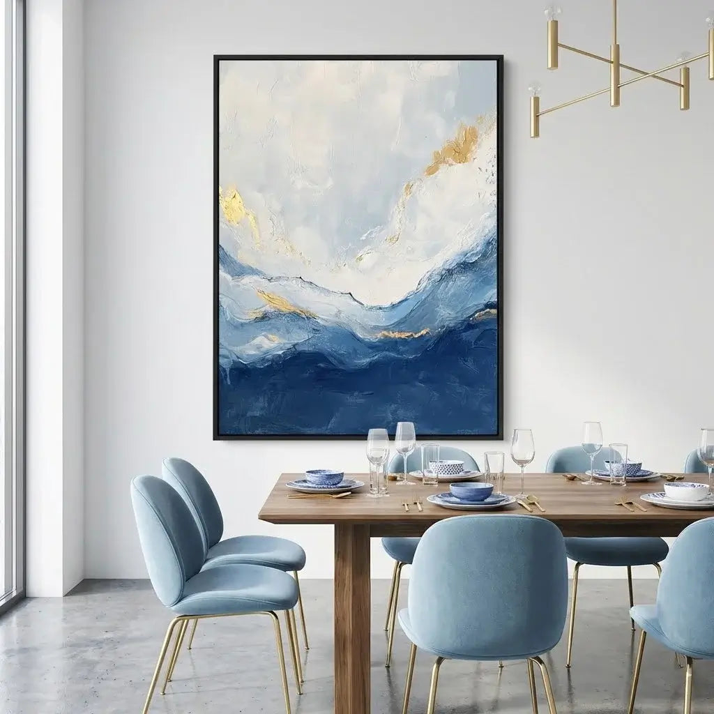Dining room with abstract art on the wall and a wooden table with blue chairs.