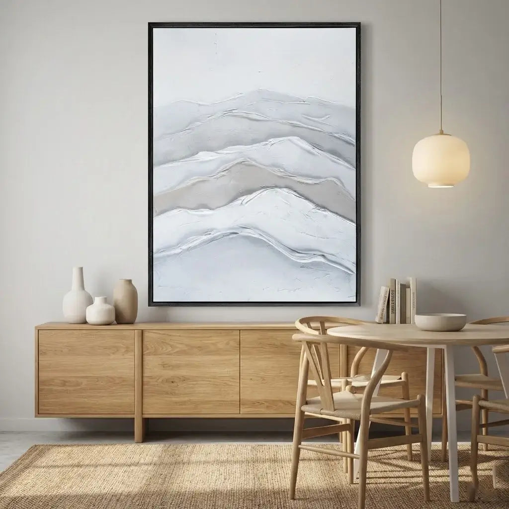 Dining room with wooden furniture, abstract mountain painting, and pendant light.