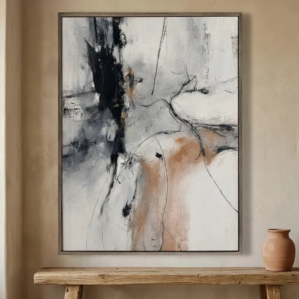 Abstract painting on a wall above a wooden table with a vase.