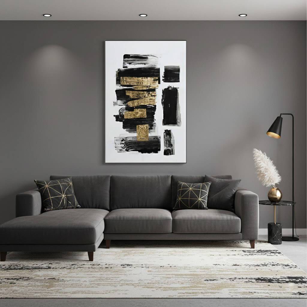 Modern living room with a gray sectional sofa, abstract art on the wall, and decorative elements.