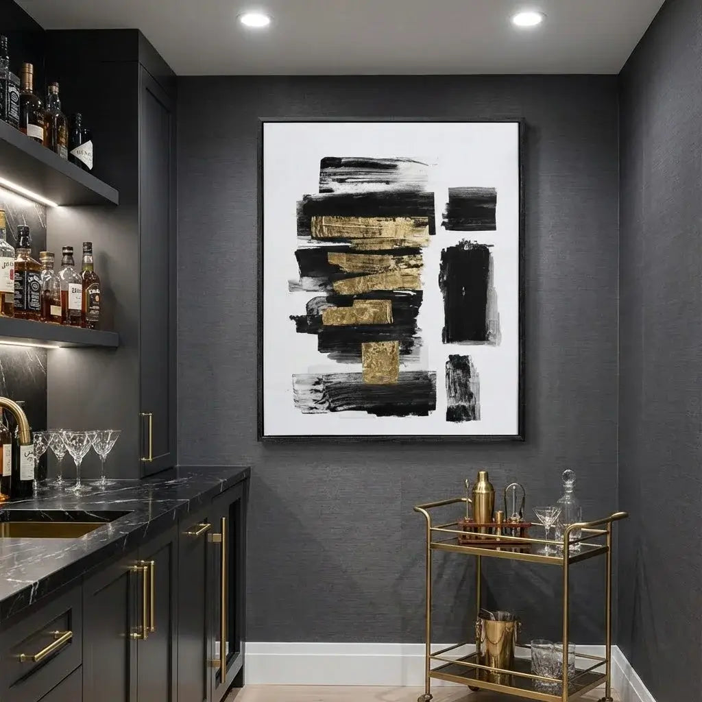 Modern kitchen with dark walls, gold accents, and a abstract art piece.
