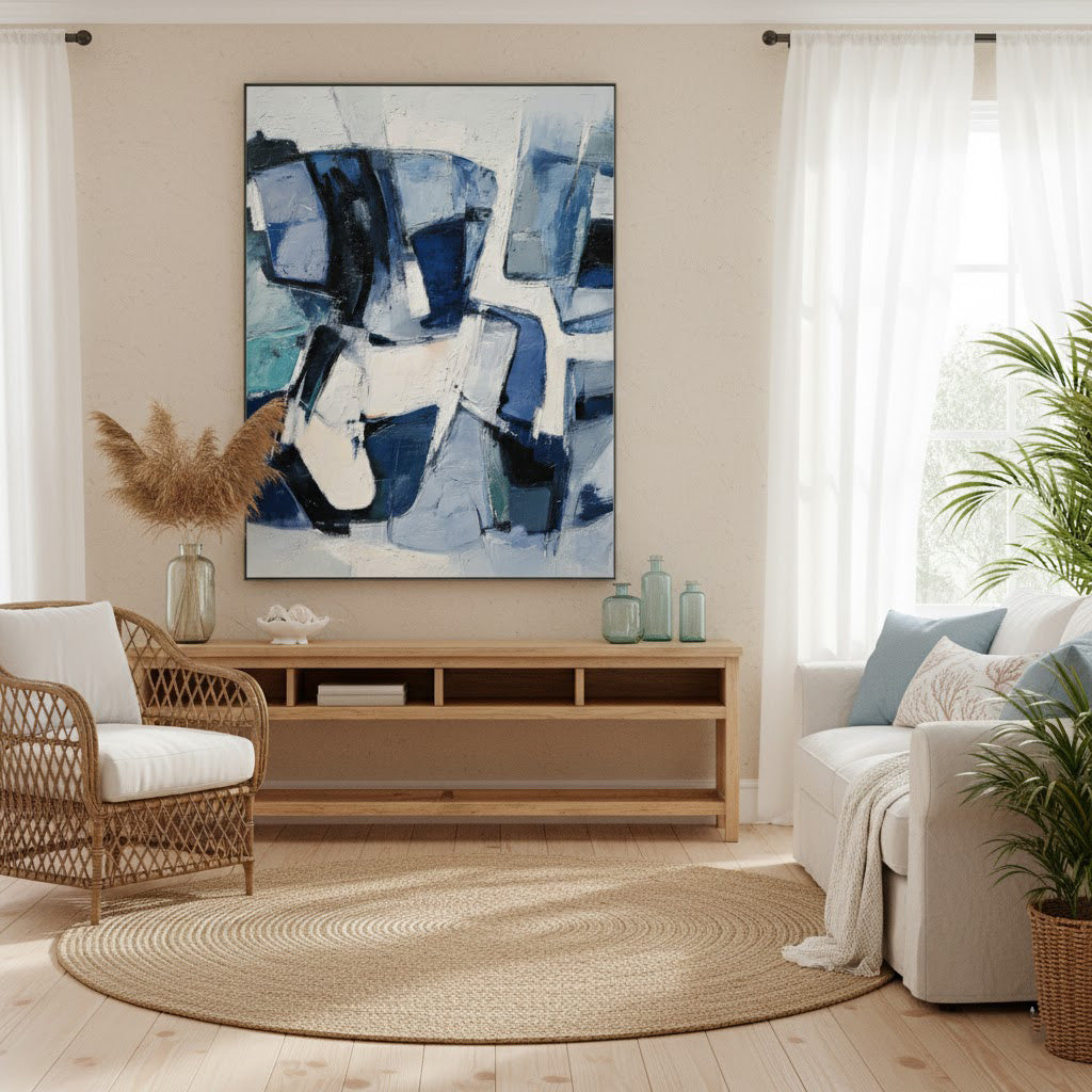 Living room with abstract art, wooden TV stand, and wicker chair.