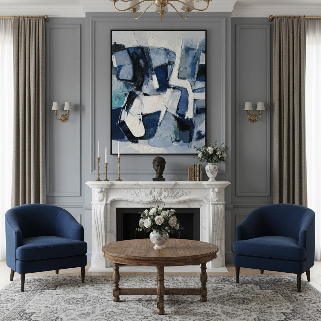 Living room with two blue armchairs, a wooden coffee table, and abstract art on the wall.