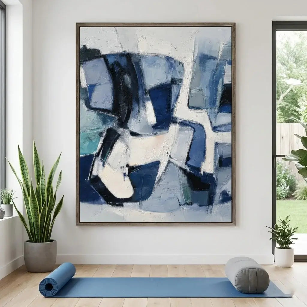Abstract art piece in a modern room with plants and a yoga mat.