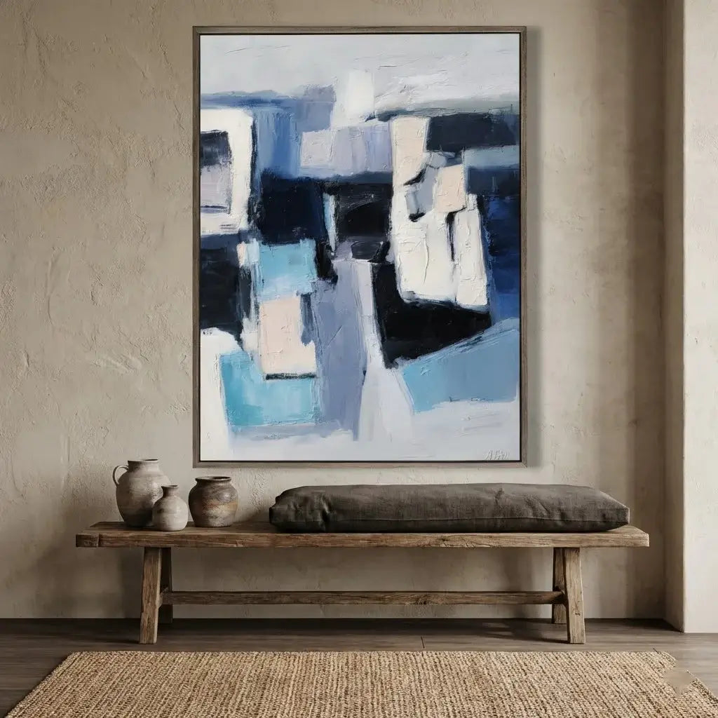 Abstract painting on a wall above a wooden bench with decorative items.
