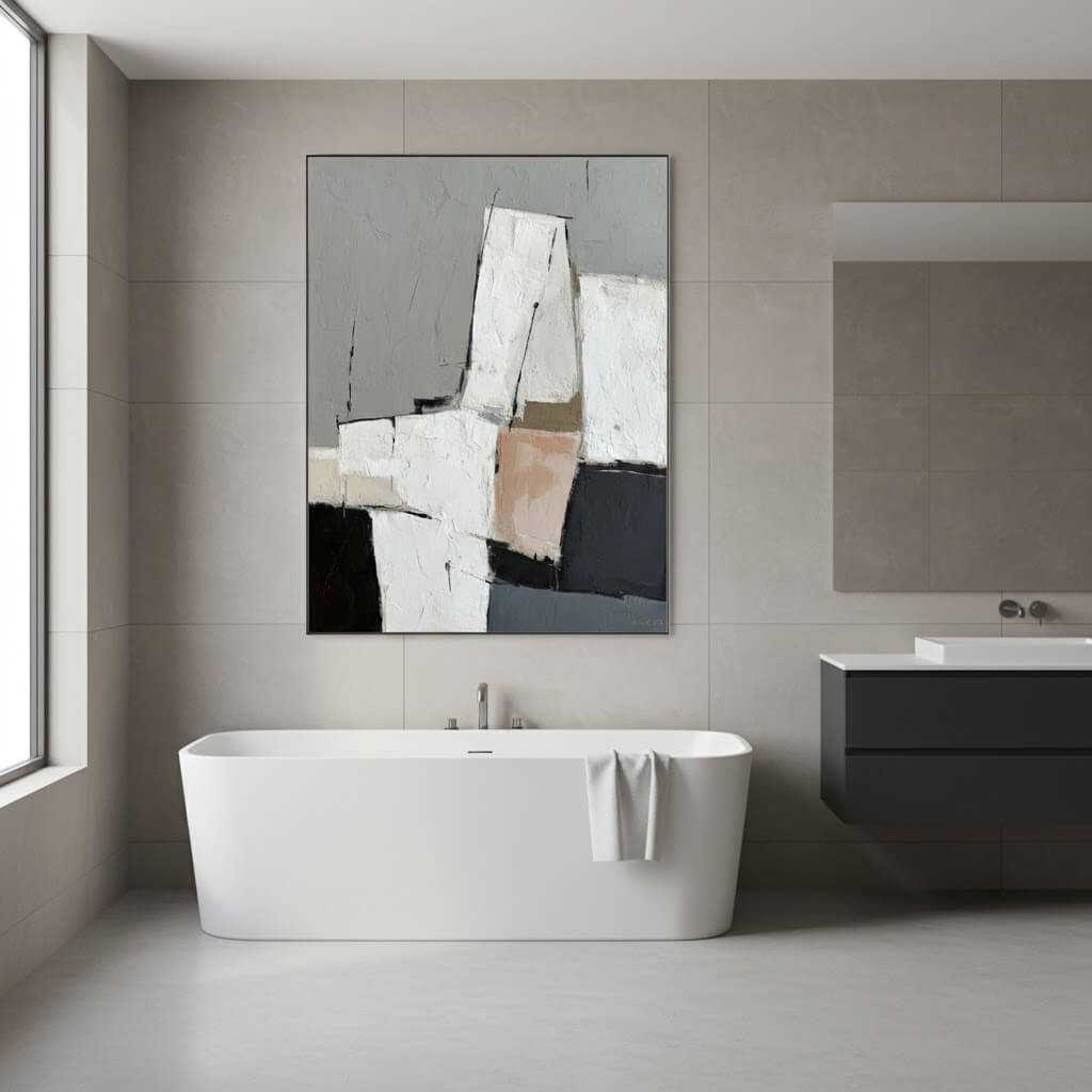 Modern bathroom with a freestanding bathtub, abstract art, and a mirror.