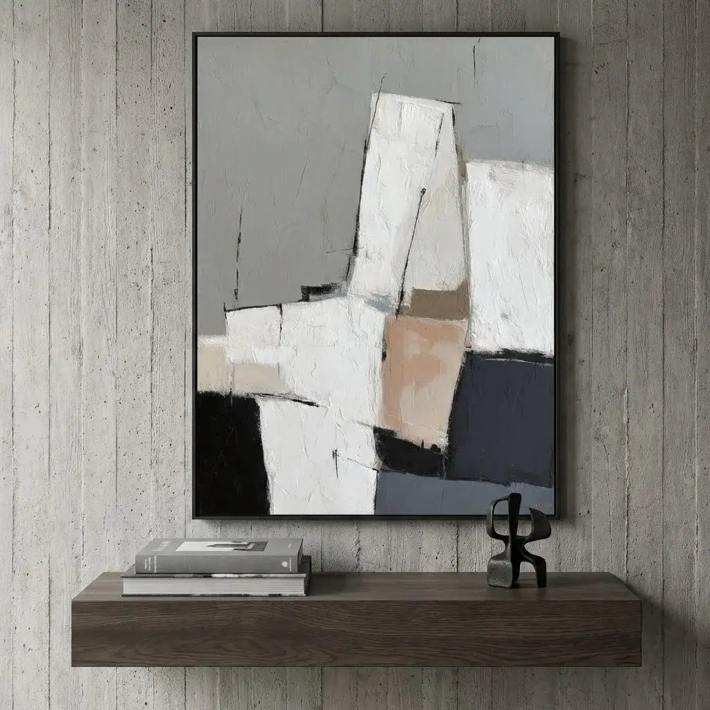 Abstract painting on a textured wall above a wooden shelf with books and a sculpture.