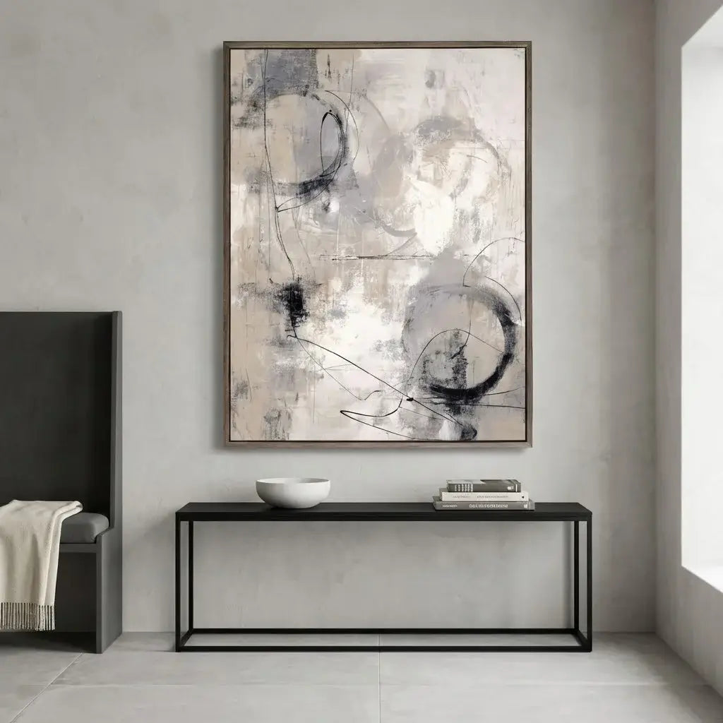 Abstract art piece on a wall above a console table in a modern interior setting.