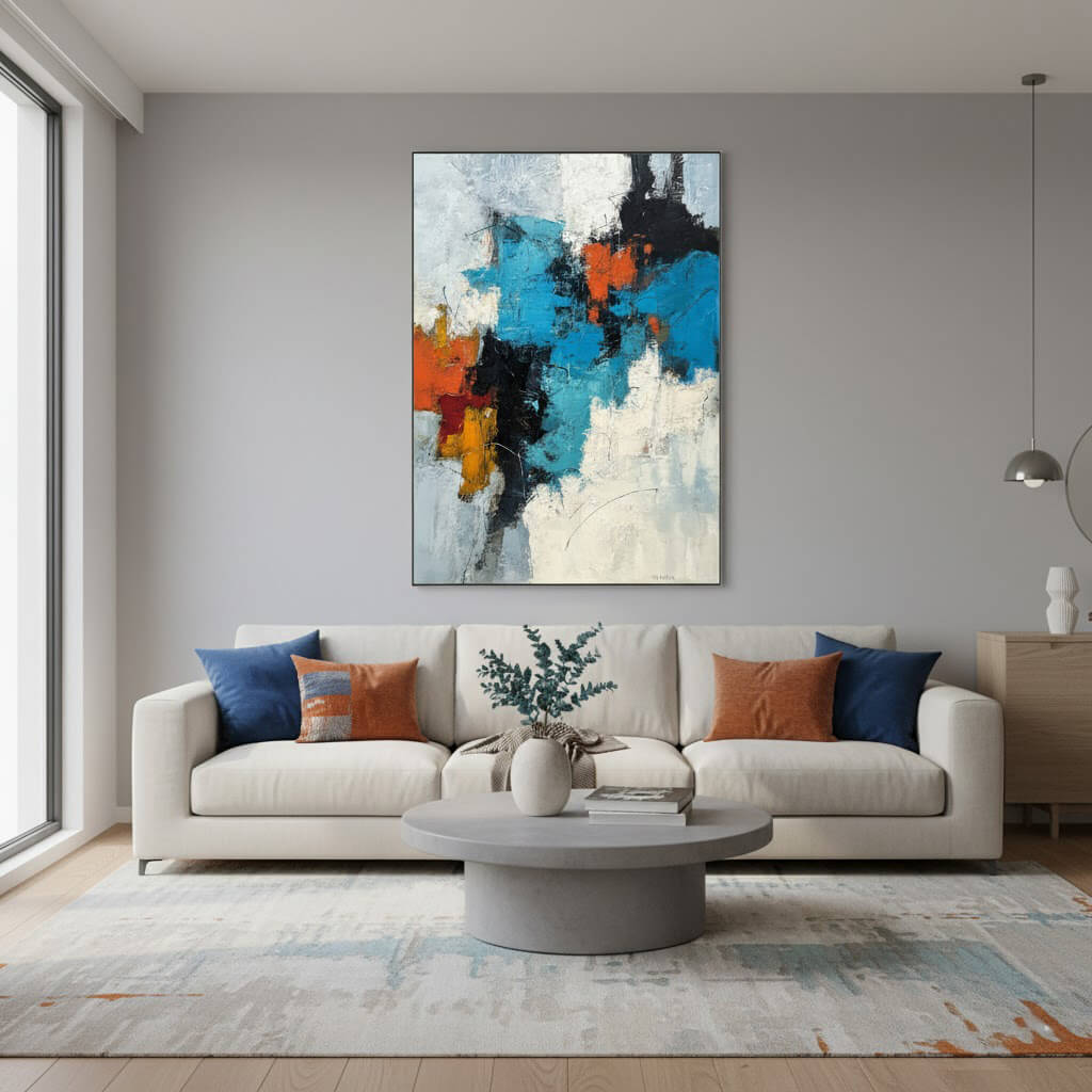 Modern living room with a gray sofa, colorful abstract painting, and round coffee table.