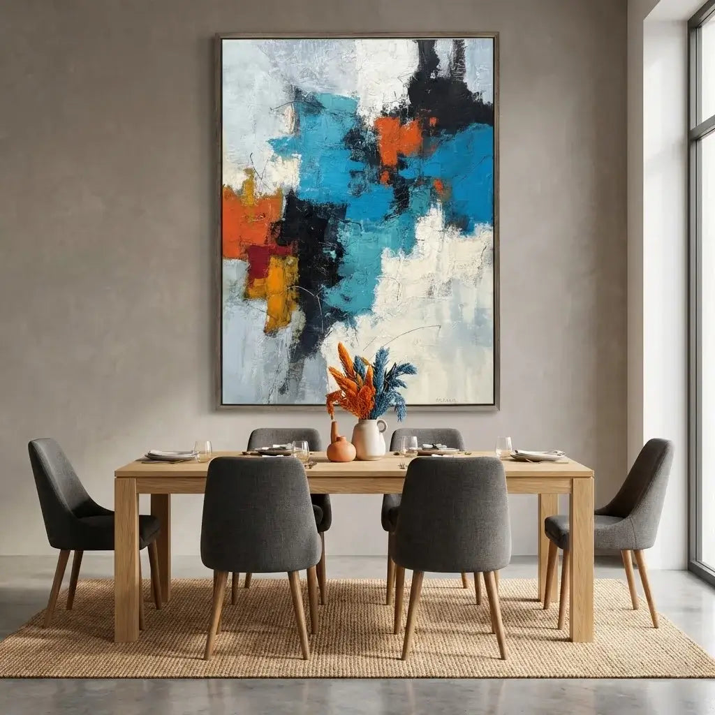 Dining room with a wooden table and gray chairs, featuring a colorful abstract painting on the wall.