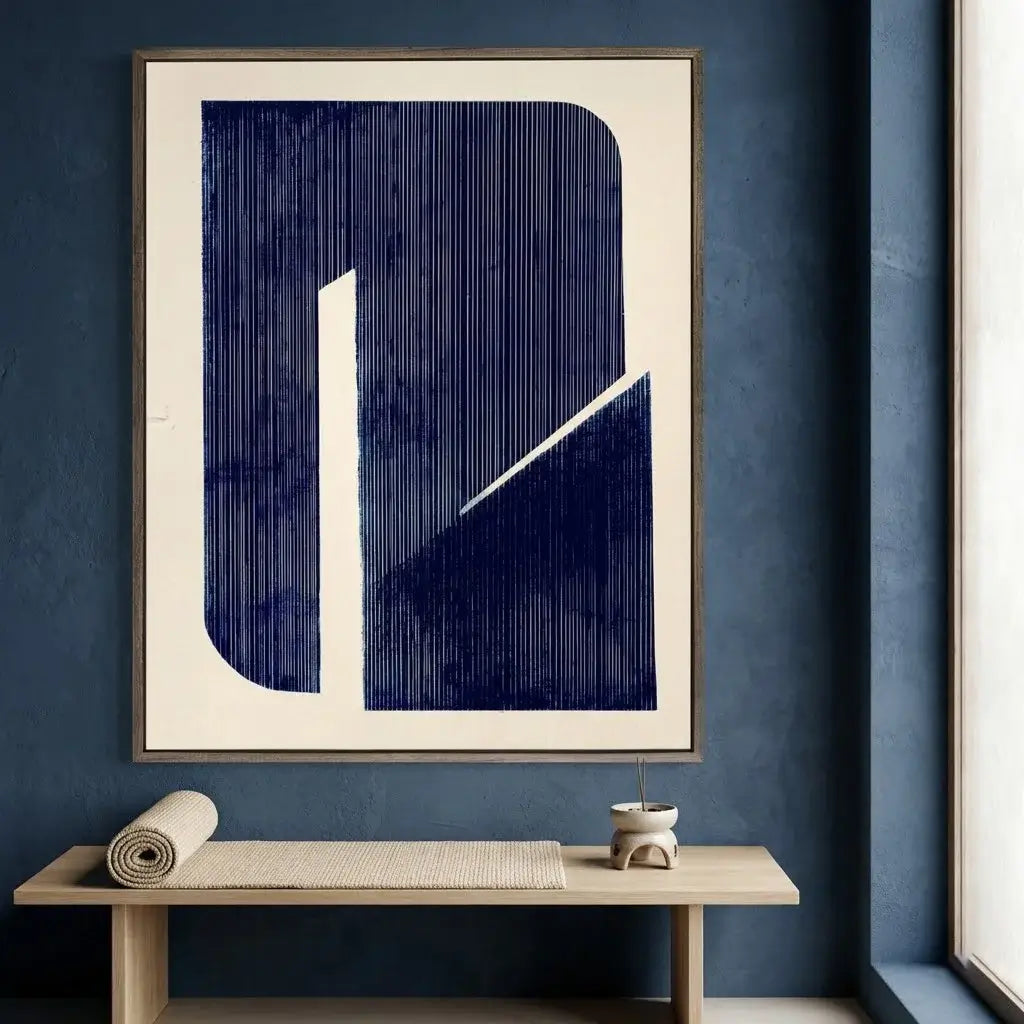Framed abstract art piece on a blue wall with a wooden table and decor items.