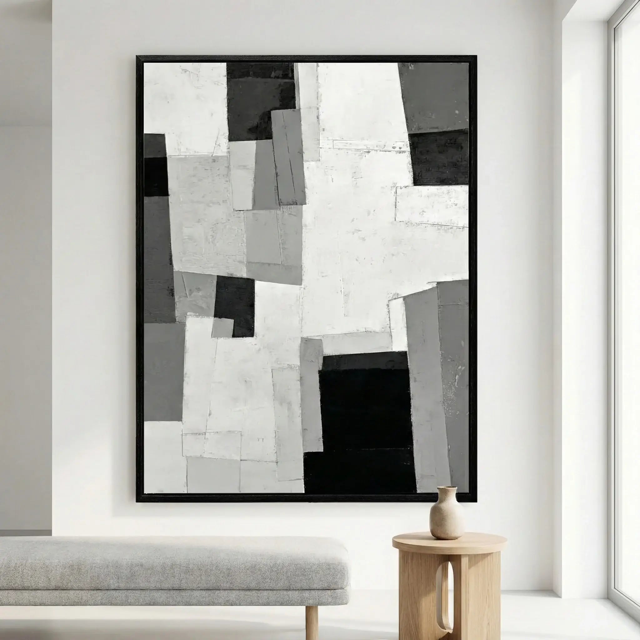 Abstract black and white artwork on a wall in a modern living room.